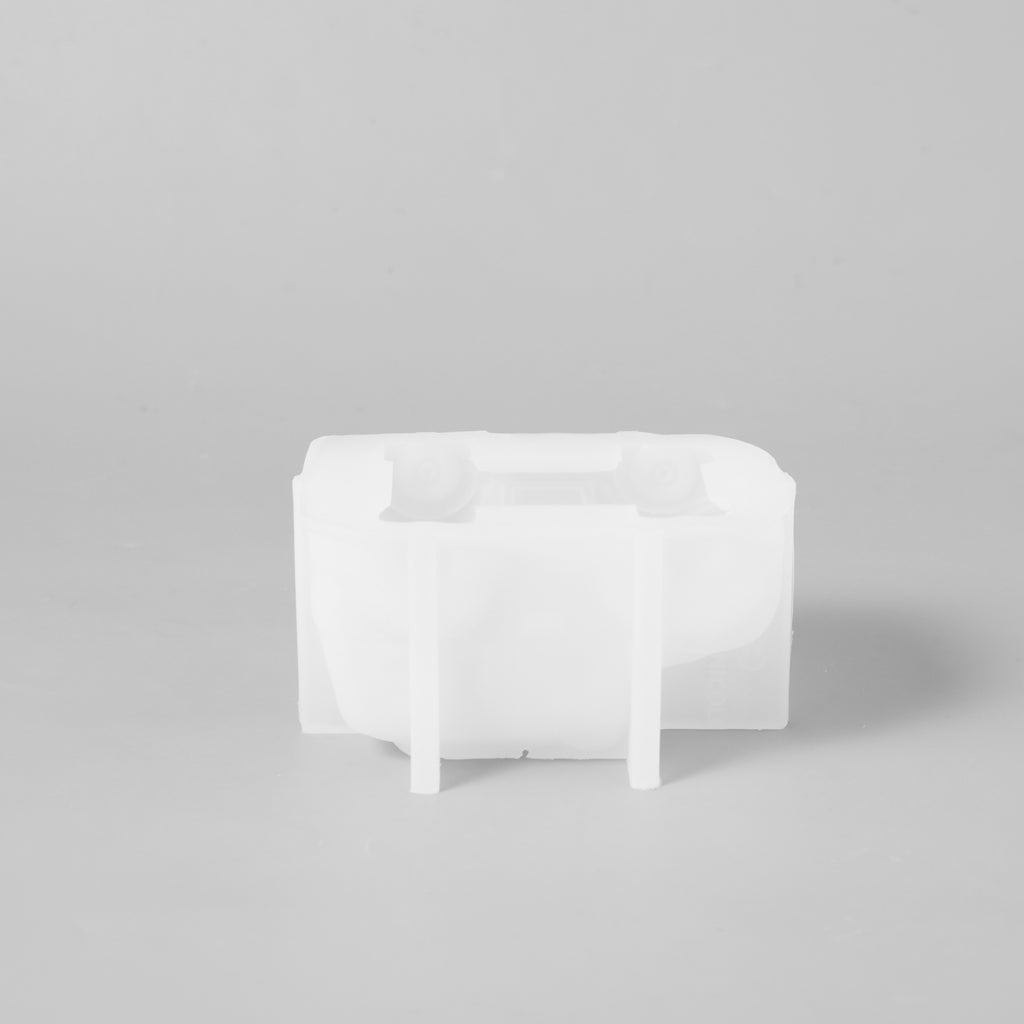 A white silicone mold for making vintage car-shaped candles, designed by Boowan Nicole.