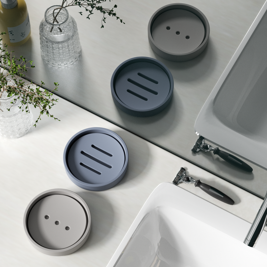 Gray and blue soap dishes are placed next to the sink, adding a touch of fun to boring life.