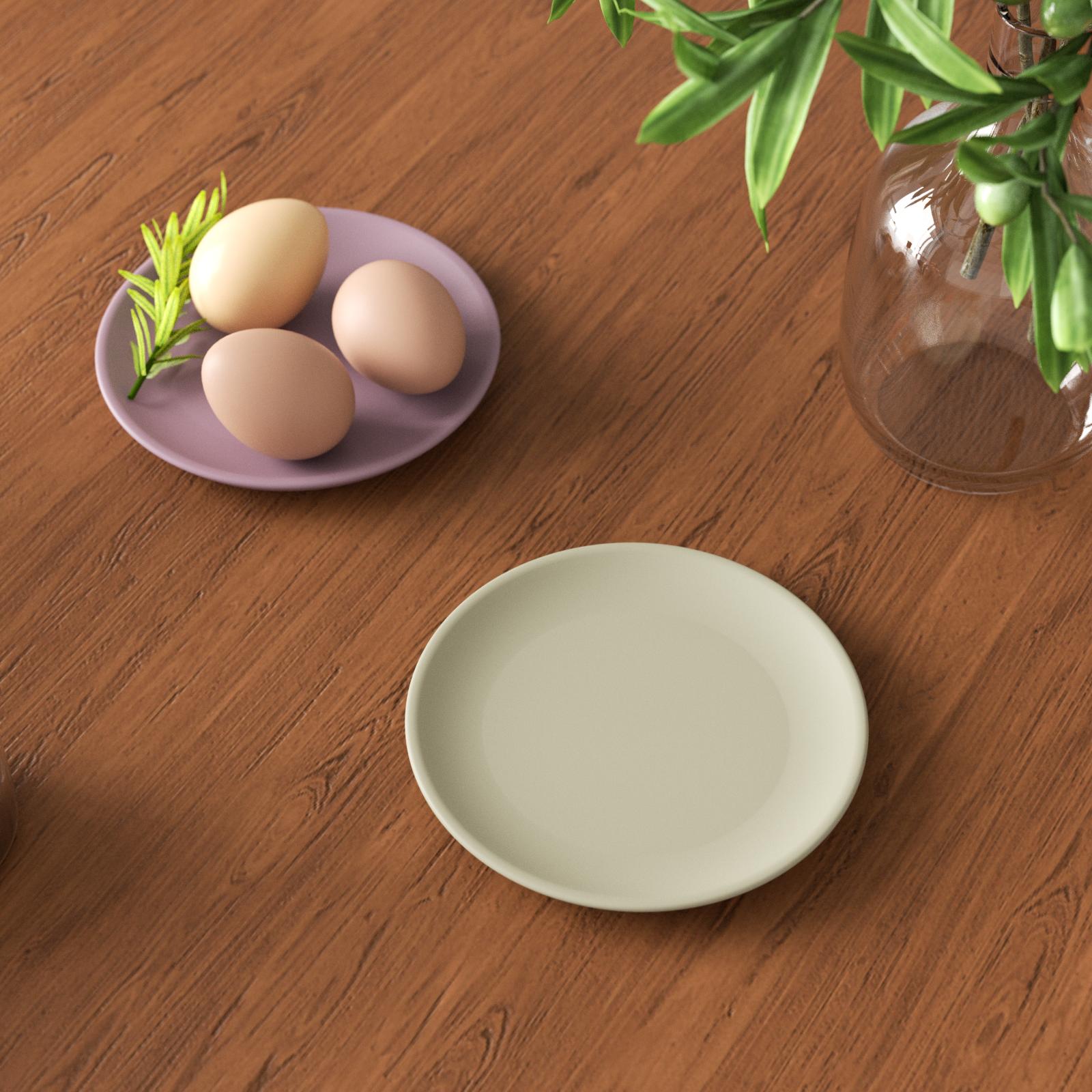 Two round trays, one containing three eggs.