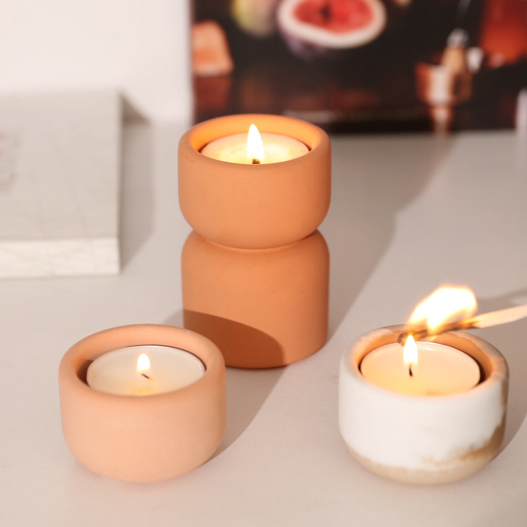 Two single and one stacked candle holder, candles flickering.