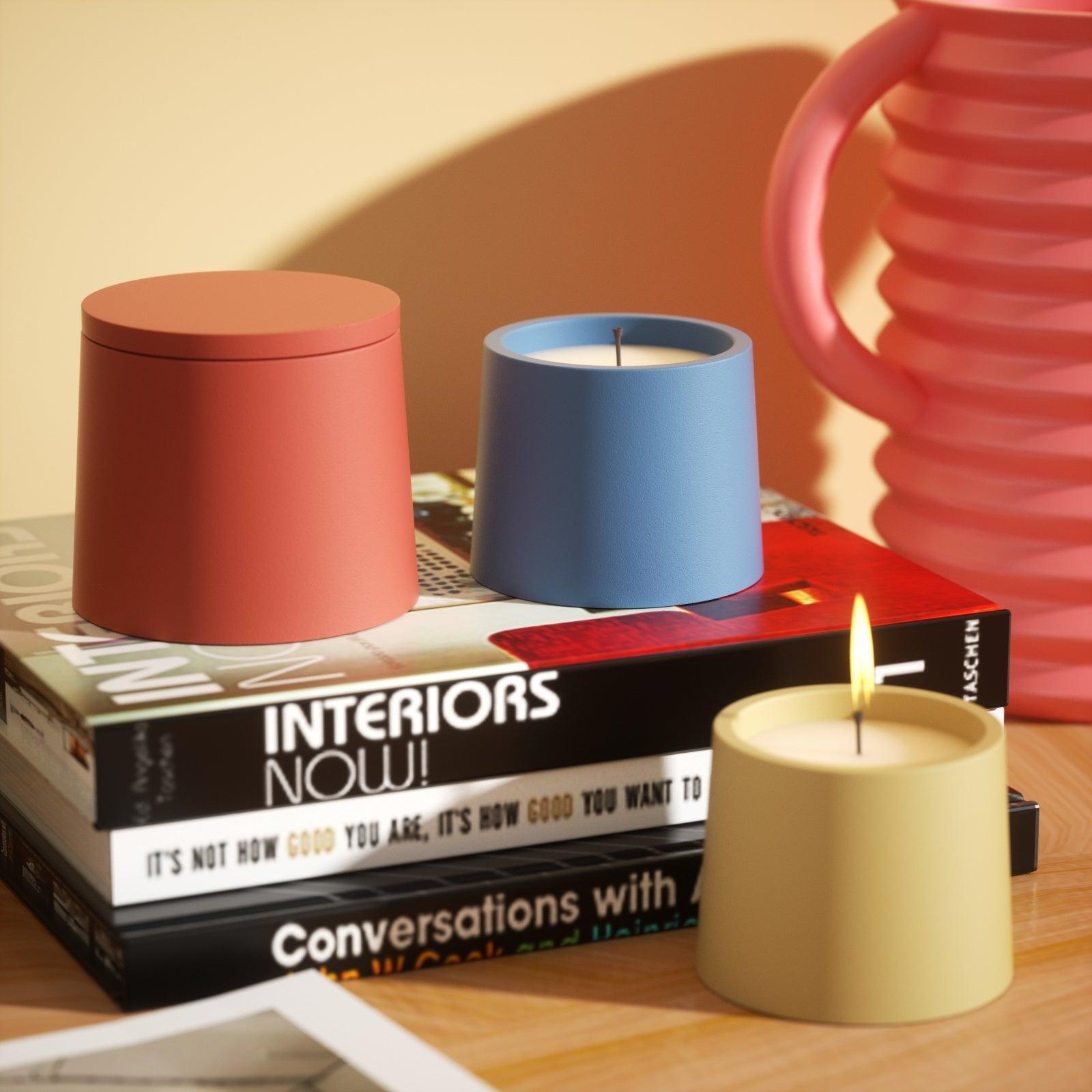 Static display of yellow, blue, and orange candle jars, showcasing the captivating variety in Boowannicole's collection.