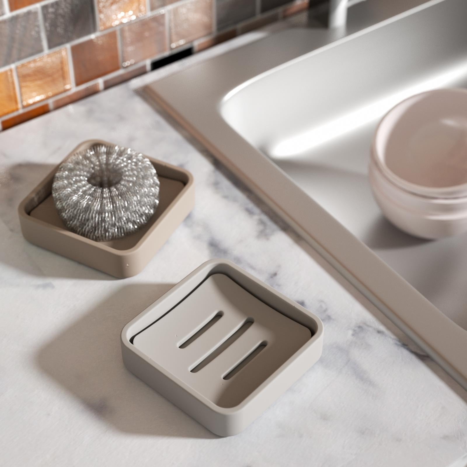 Two gray soap boxes, with one containing steel wool pads.