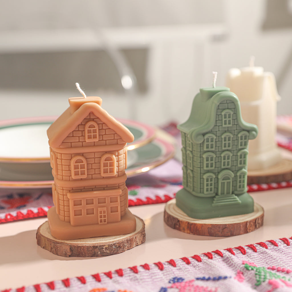 On the dining table, two Sweet Residence candles are placed on wooden bases.