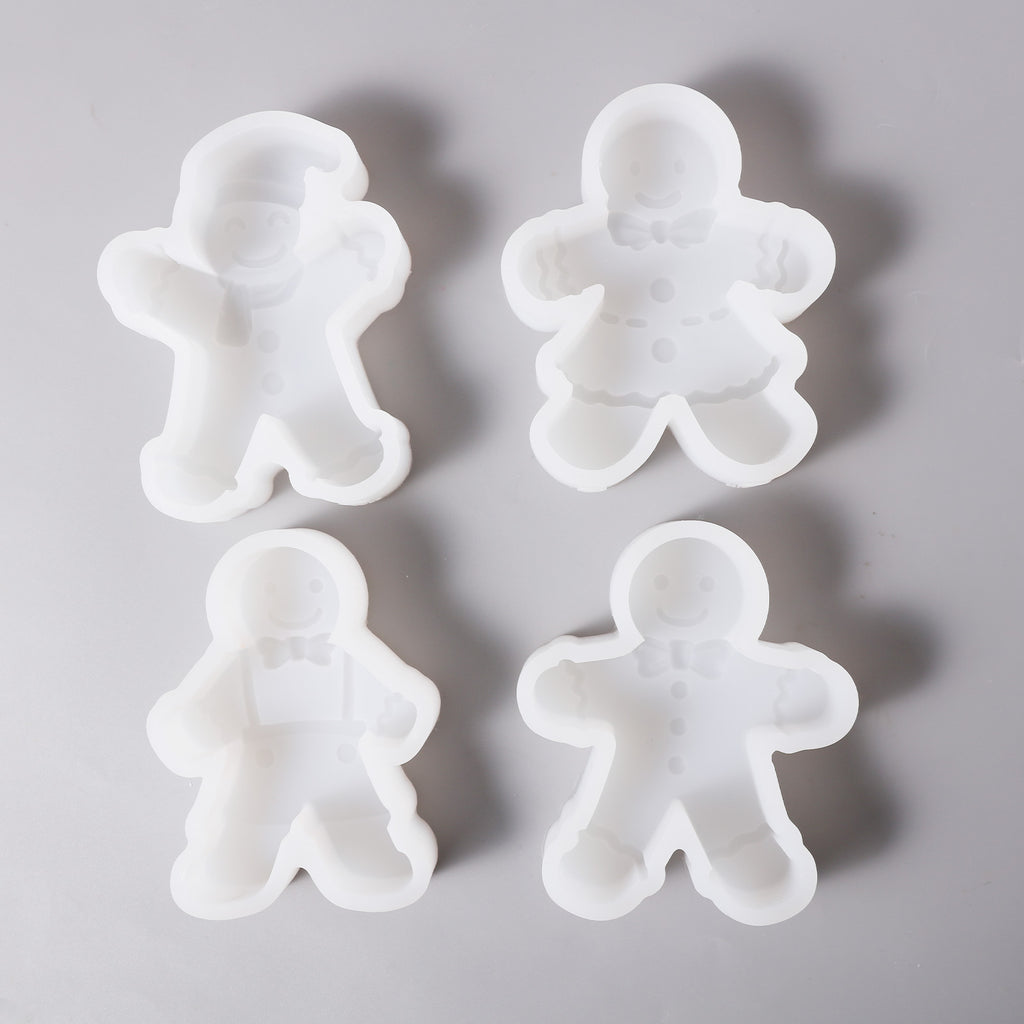 Four different designs of white silicone molds for making gingerbread man candles, designed by Boowan Nciole.