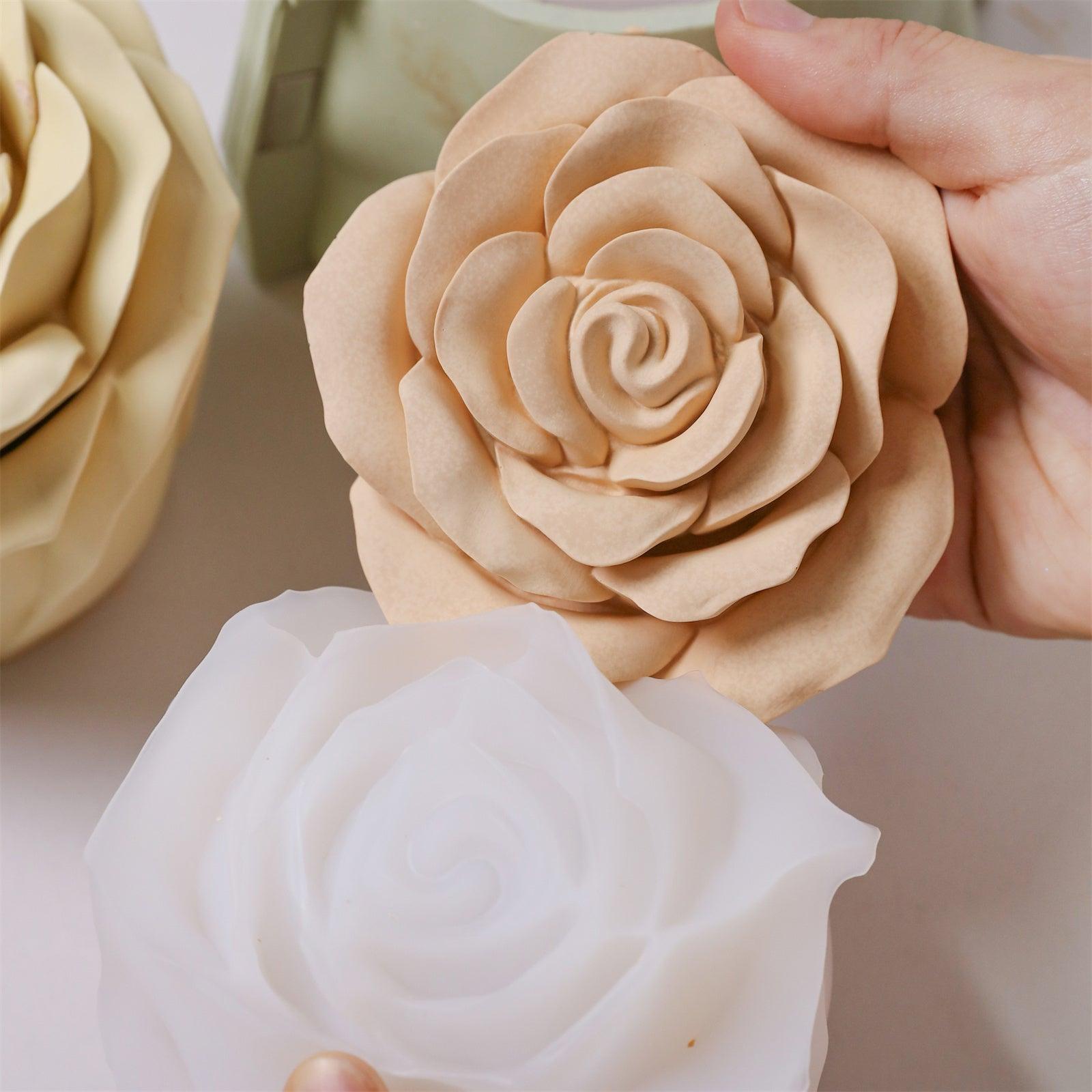 Demolding a beige rose-shaped candle jar from a white silicone mold.
