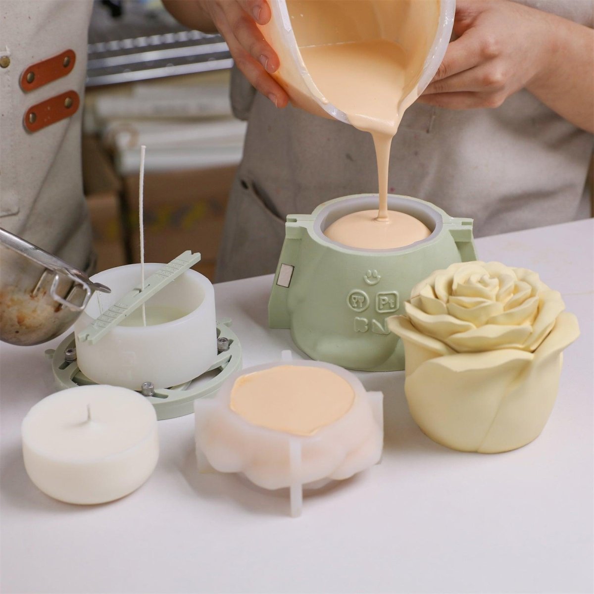 Pouring prepared concrete and wax liquid into silicone molds with support shells and into candle molds - Boowan Nicole