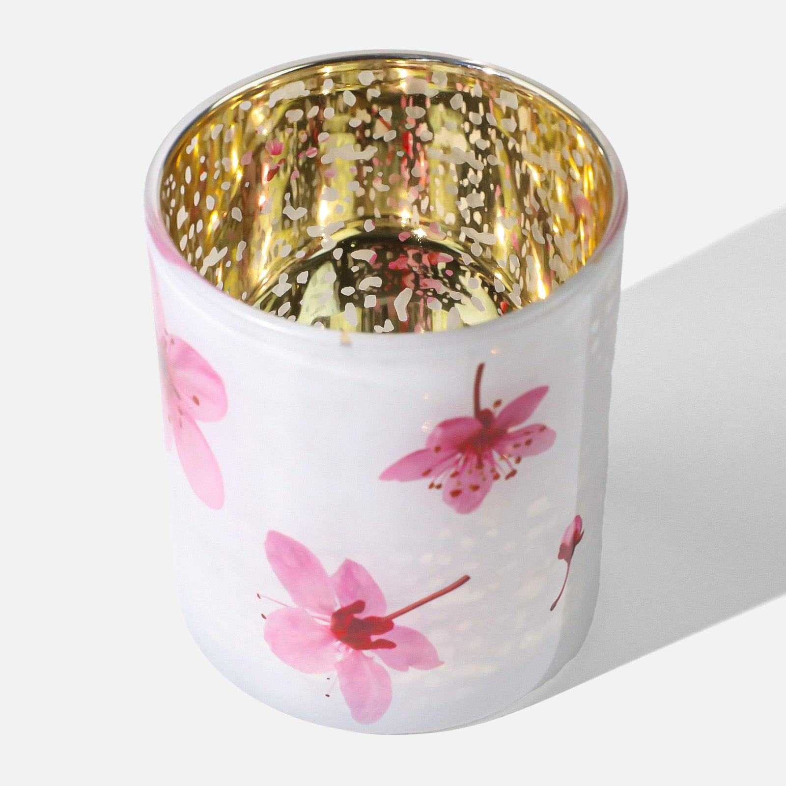 Top View of Frosted White Sakura Glass Candle Cup With Speckled Gold Interior and Scattered Pink Blossom Prints - Boowan Nicole
