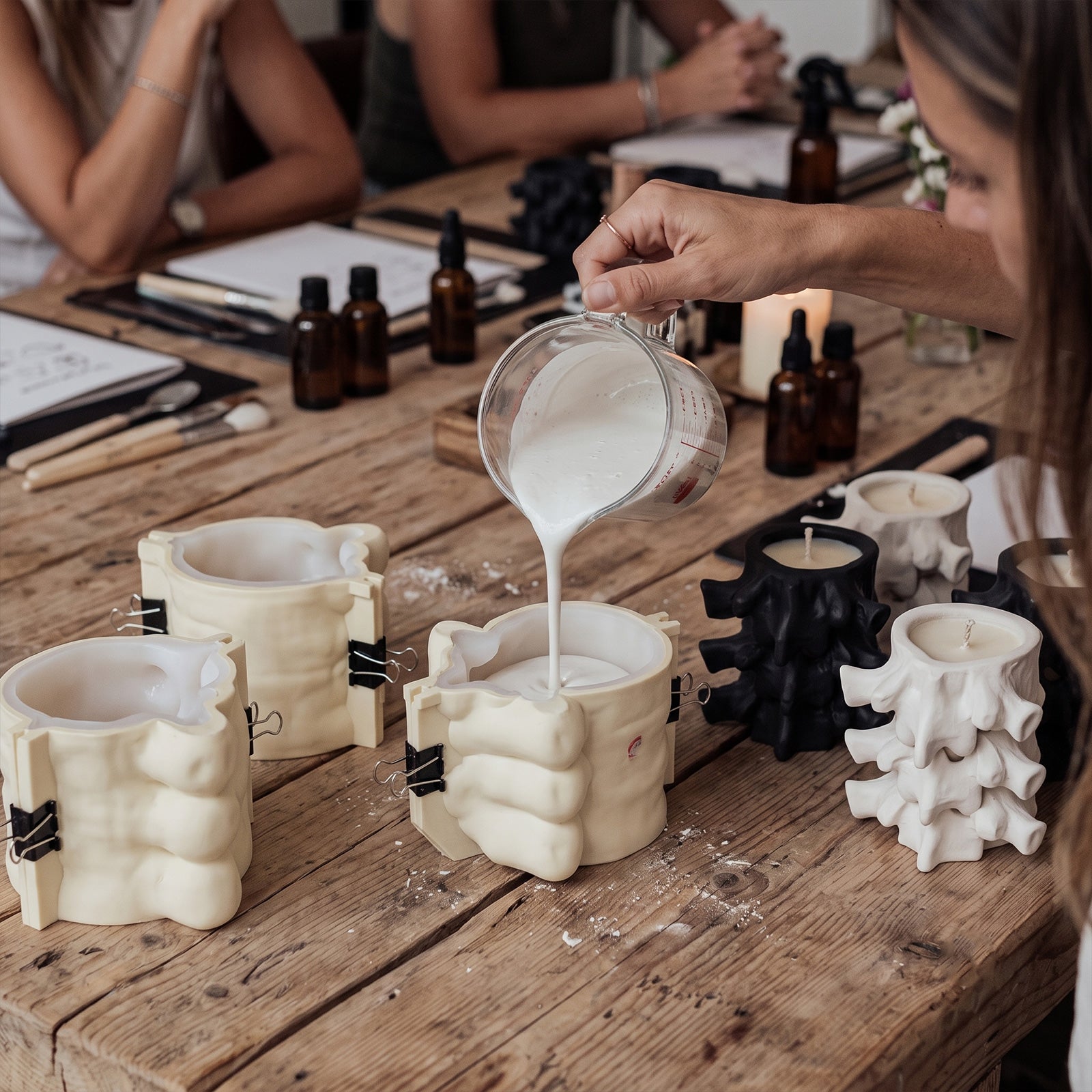 Pouring plaster into Haunted Spine Candle Jar silicone mold, DIY candle making workshop - Boowan Nicole