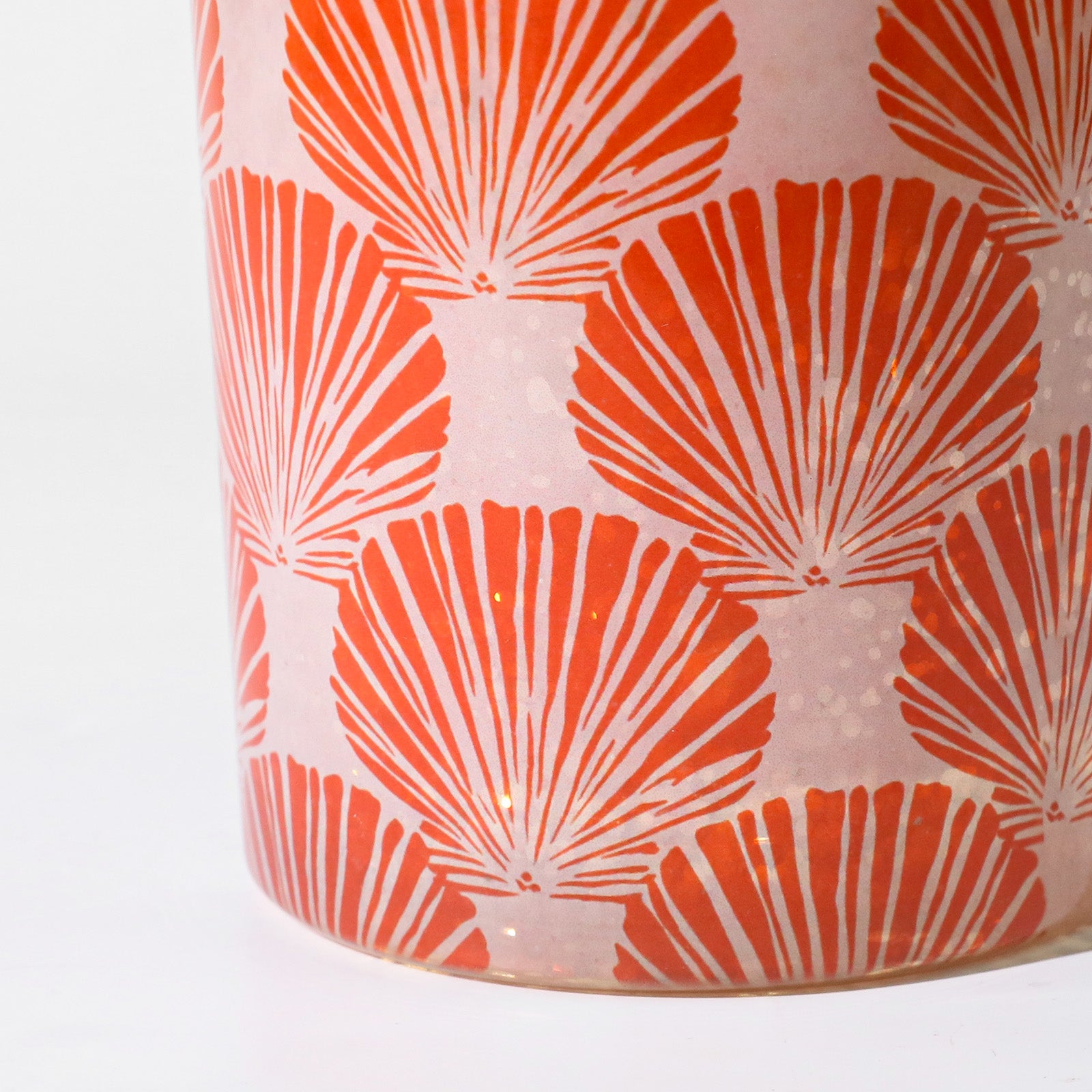 Macro Close-up of Vivid Orange Fan Scallop Shell Repeat Pattern on Frosted Candle Glass Surface - Boowan Nicole