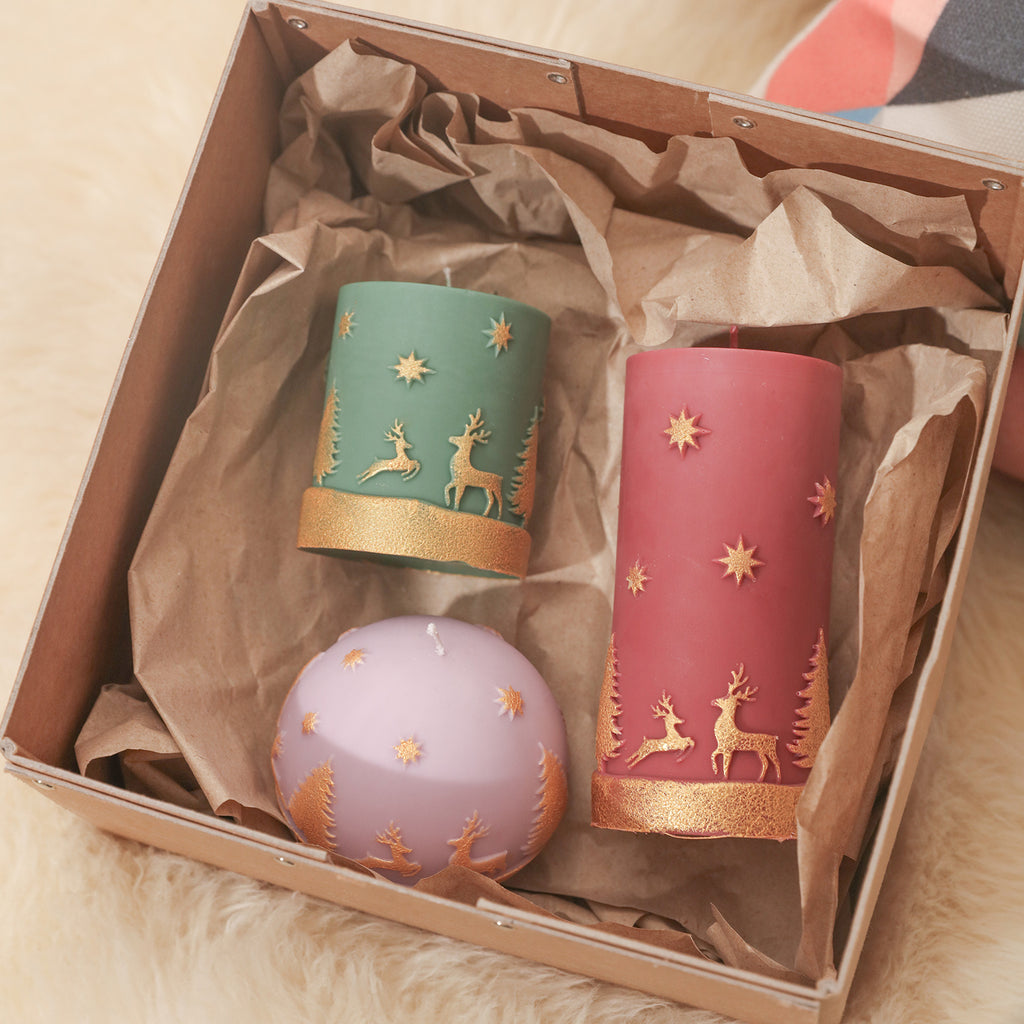 Green short style, red long style, and purple dome-shaped Christmas pattern candles are placed in gift boxes to share the happy design with others Boowan Nicole.