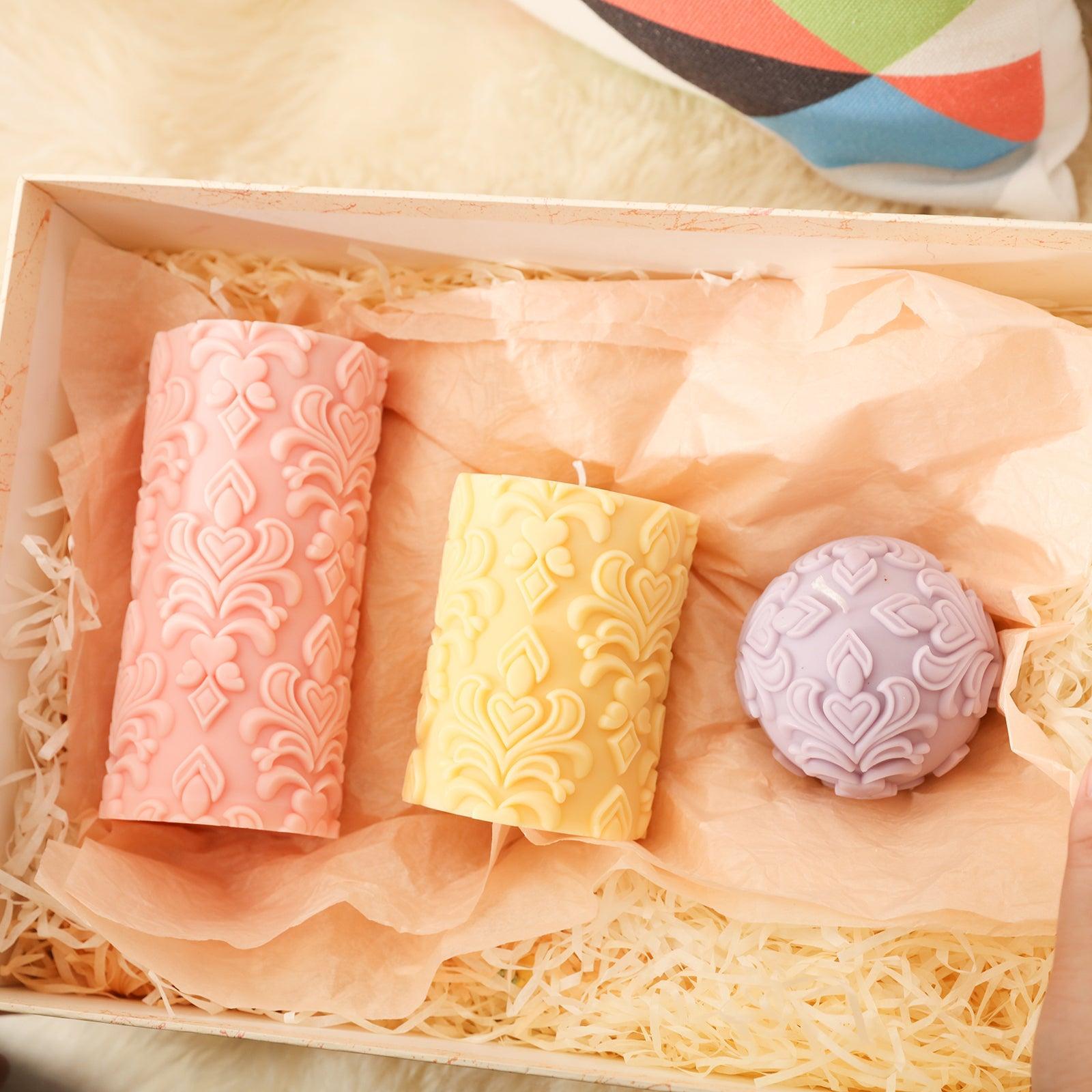 Three relief candles in gift boxes.
