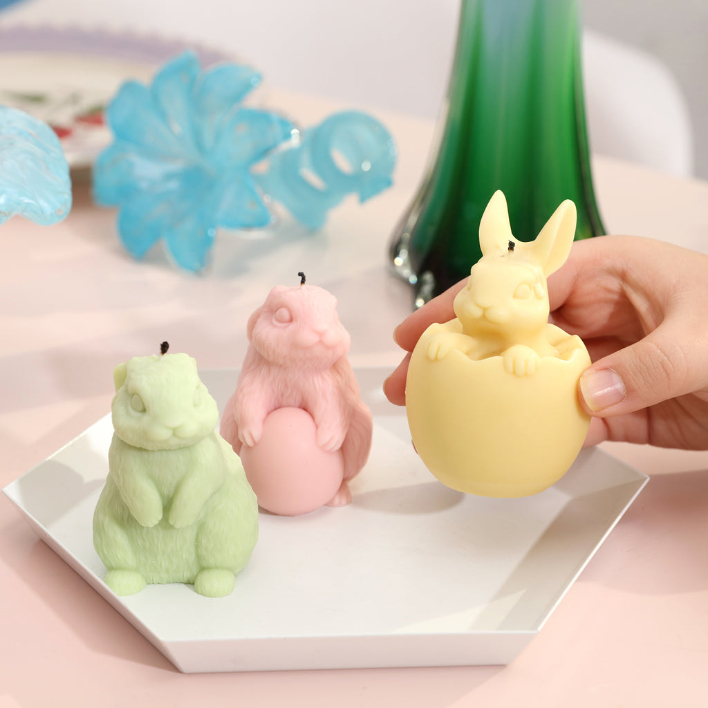 A tray with green, yellow, and pink Easter bunny candles, rich in color, adding to the joy of the holiday.