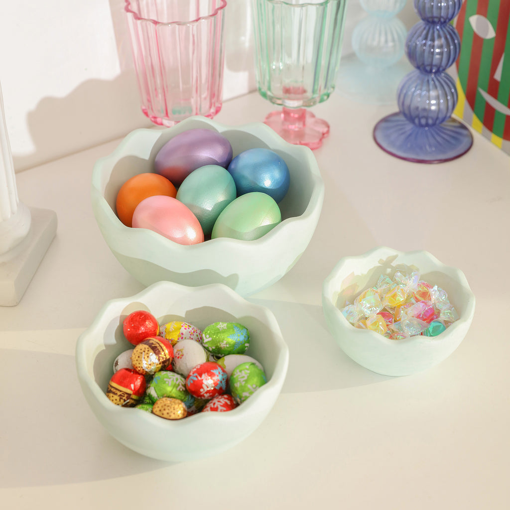 Candies, Easter eggs, chocolate, and Easter eggs of different colors placed in eggshell bowls of different sizes