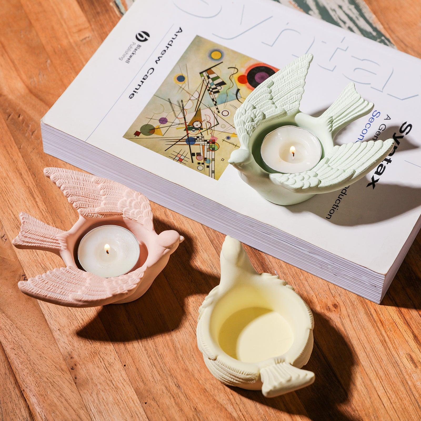  A harmonious arrangement of three tea light holders on the tabletop, creating a visually appealing display.