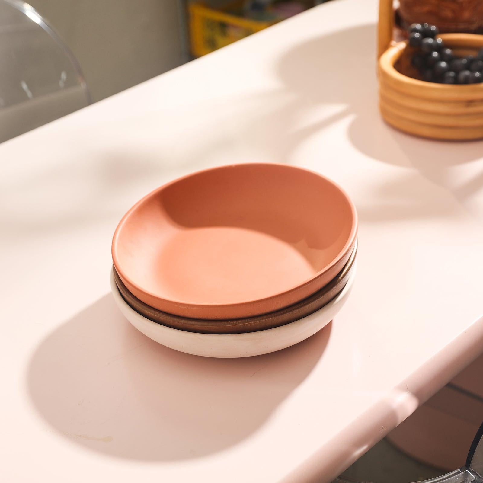 Three large round trays stacked on top of each other on the dining table.