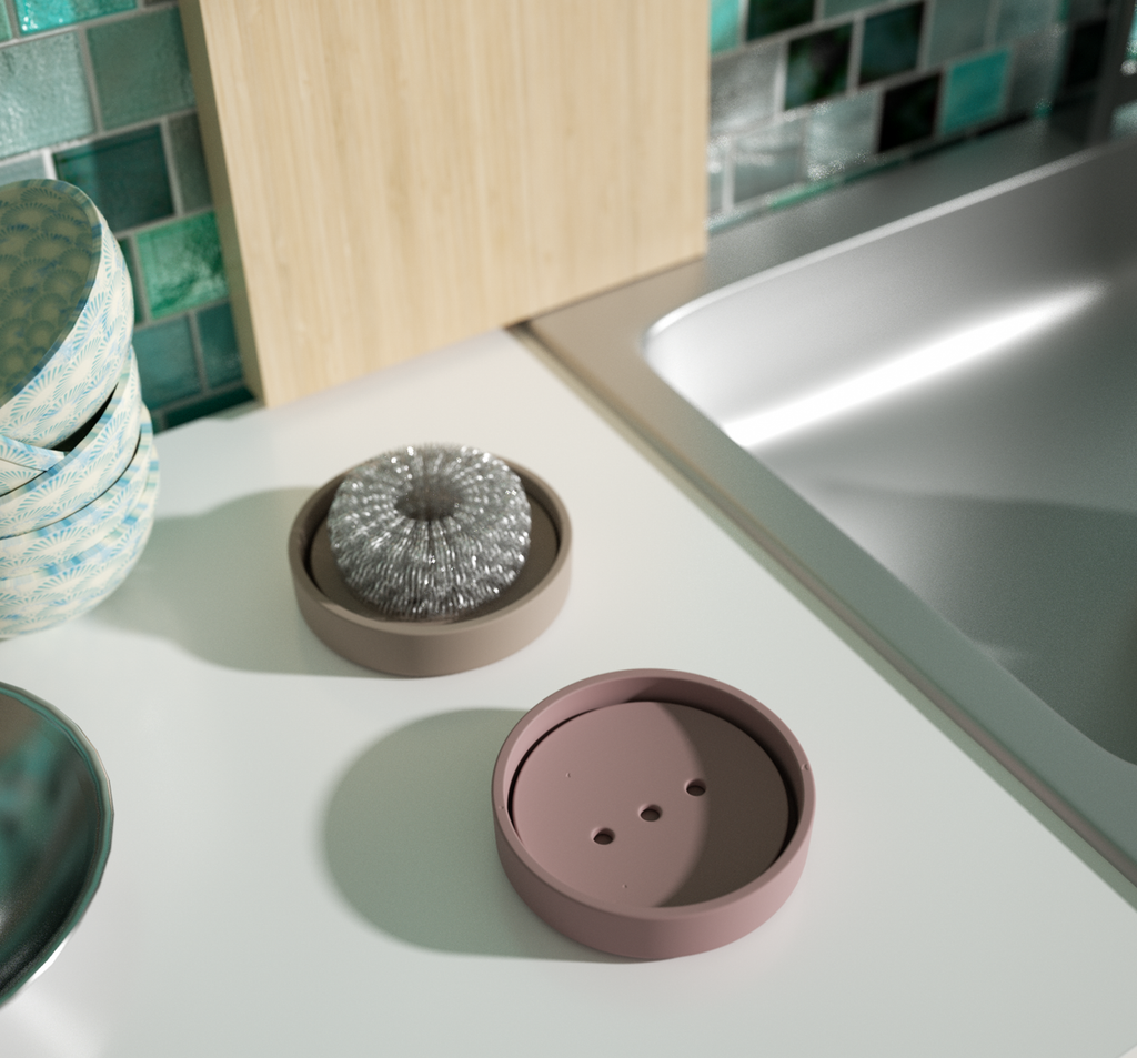 The taupe and blue soap dishes are placed next to the kitchen sink, adding to the usage scene and reflecting the design ingenuity of boowannicole
