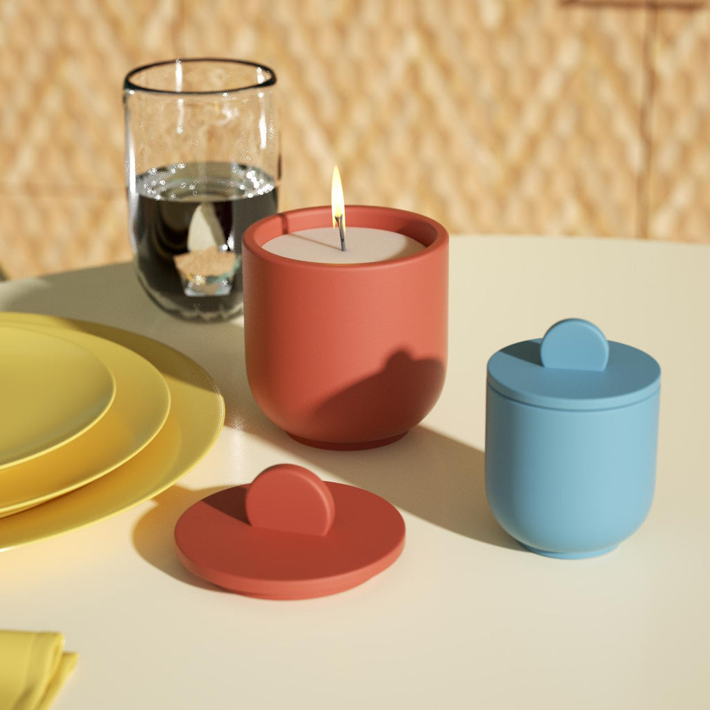 Candles burning in orange candle jar