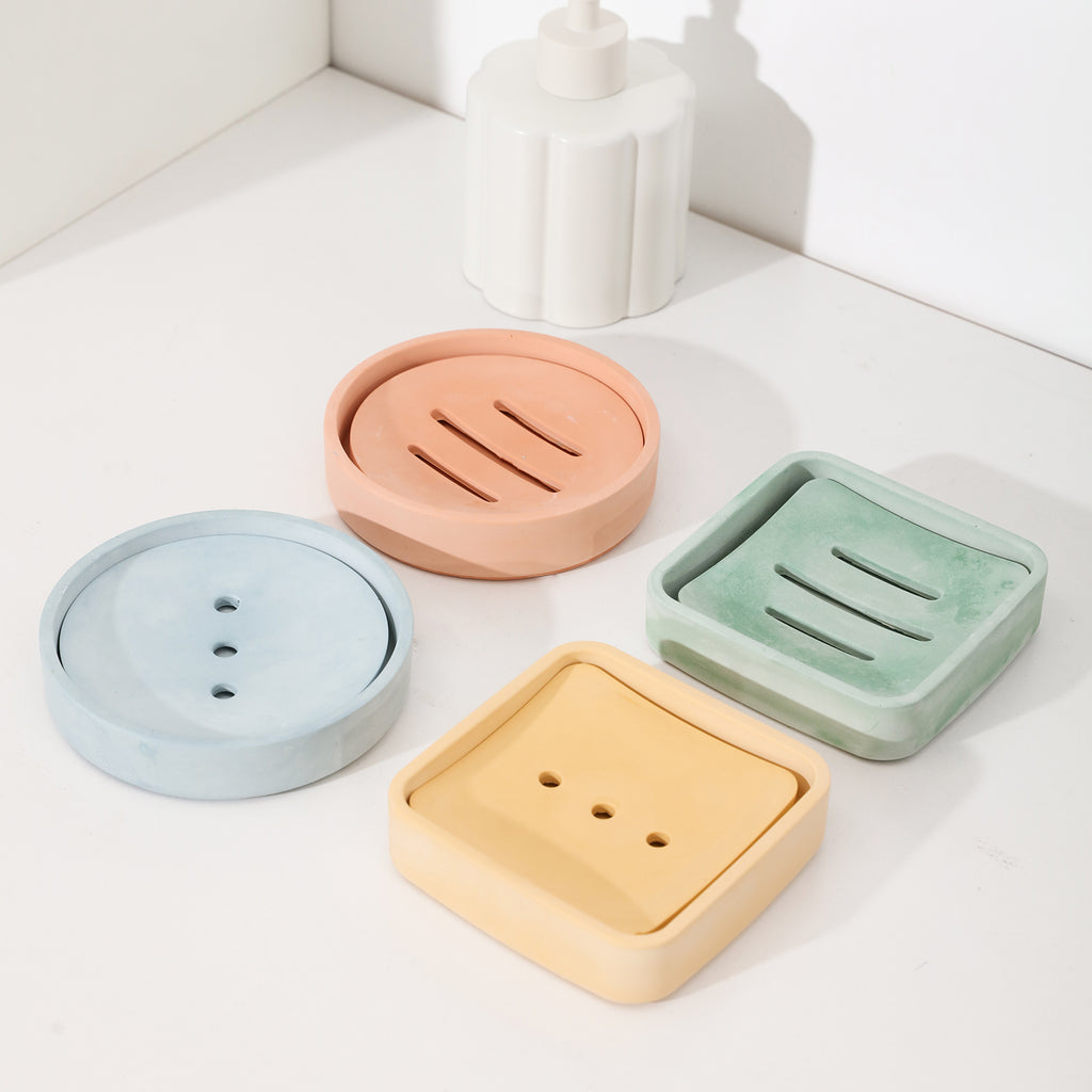 Four soap boxes in different colors and shapes, offering diverse choices.