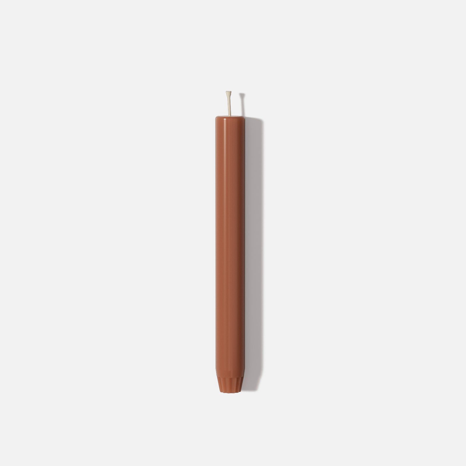 9.3" classic taper candle in terracotta brown with straight sides, rounded tip, and fluted base - Boowan Nicole