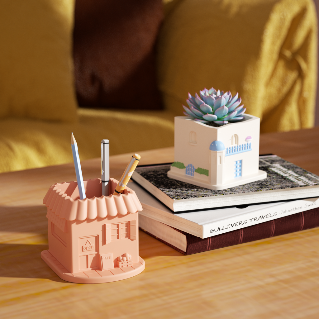 Plants are planted. The white Aegean Santorini House Plant Pot is placed next to the book. The pink plant pot has a gel pen inserted in it - Boowan Nicole
