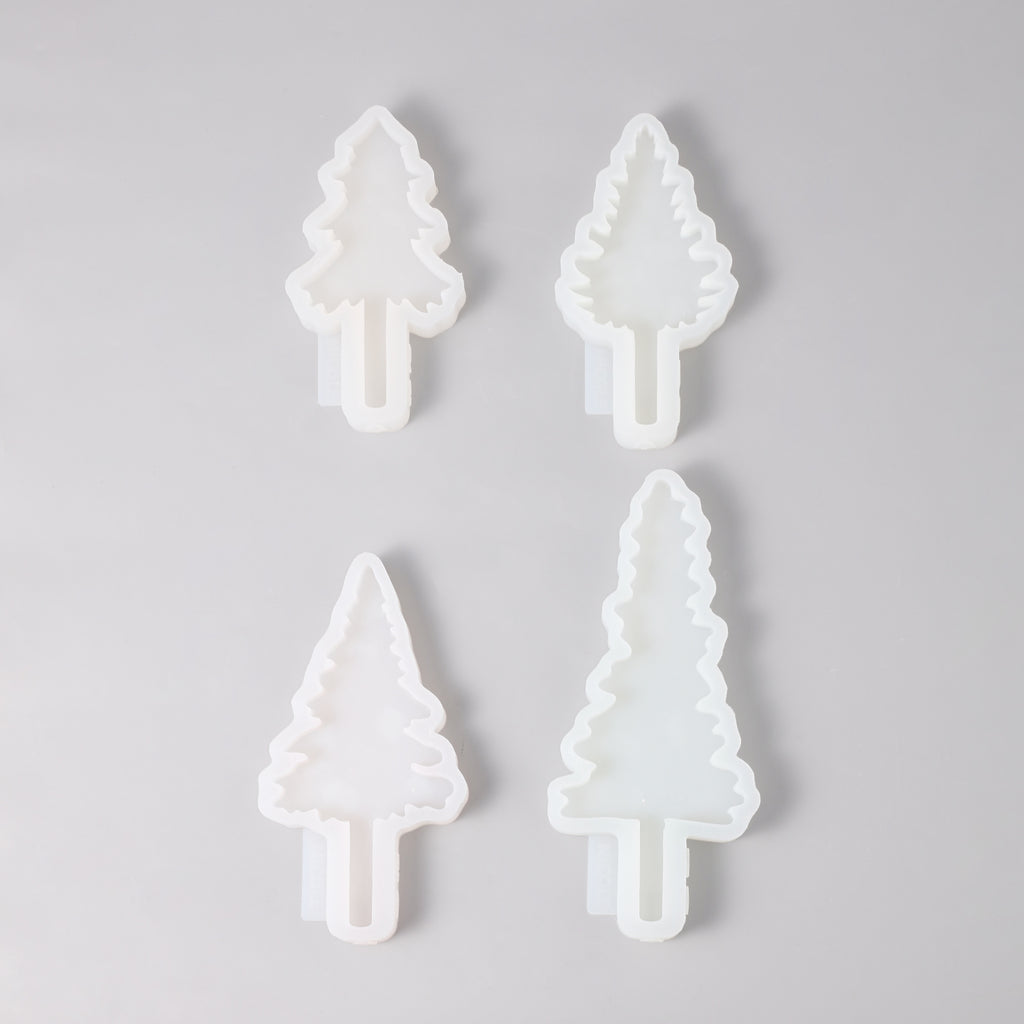 Four Christmas tree-shaped silicone molds of different sizes and shapes.