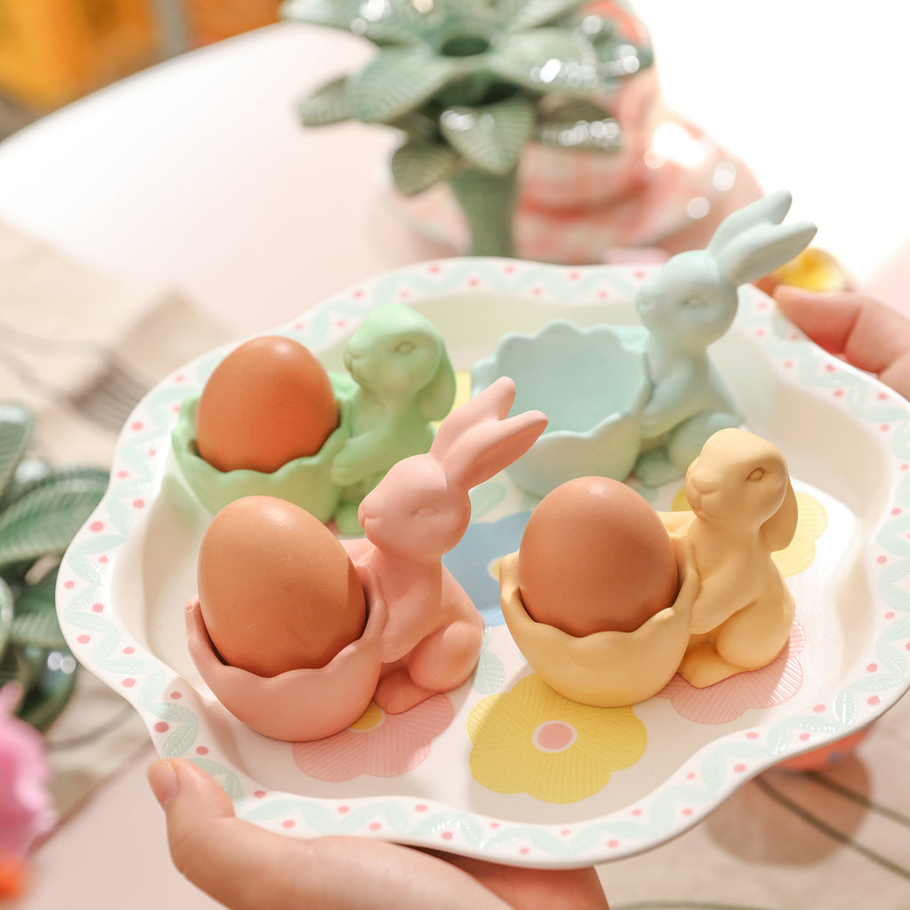 Four Easter Bunny egg cups placed on a tray