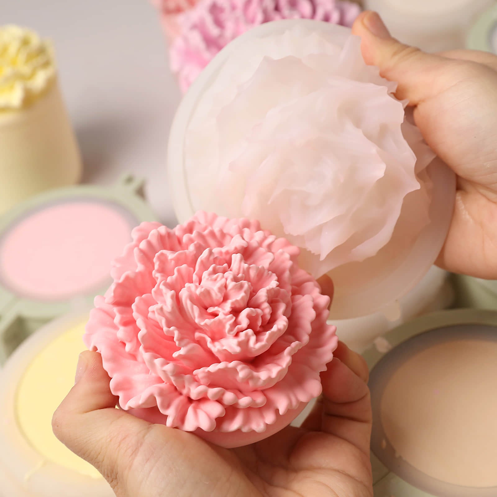 Unmolding a vibrant pink carnation candle lid from a flexible silicone mold -Boowan Nicole