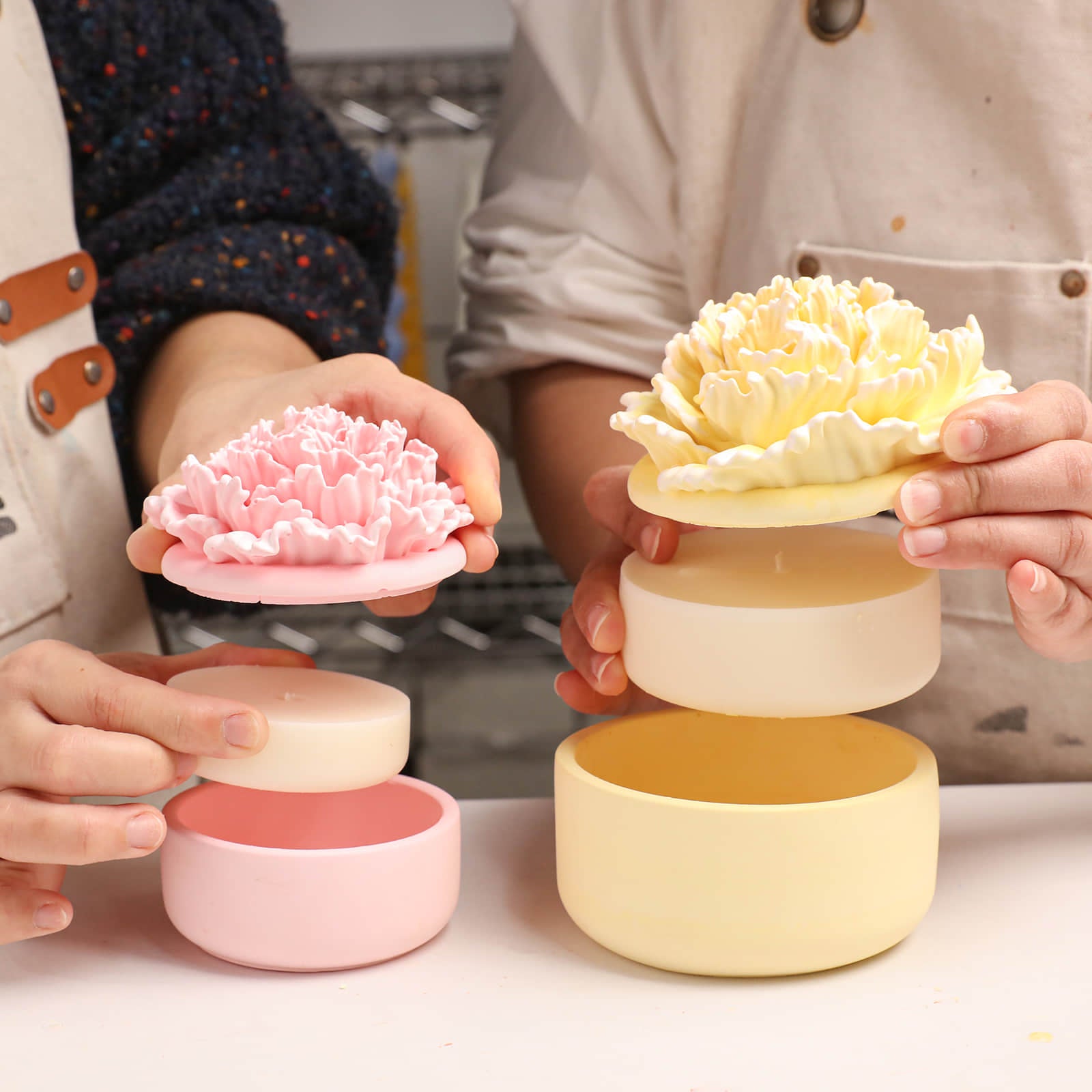 Demonstrating the refillable design of carnation candle jars with separate lids and refills -Boowan Nicole