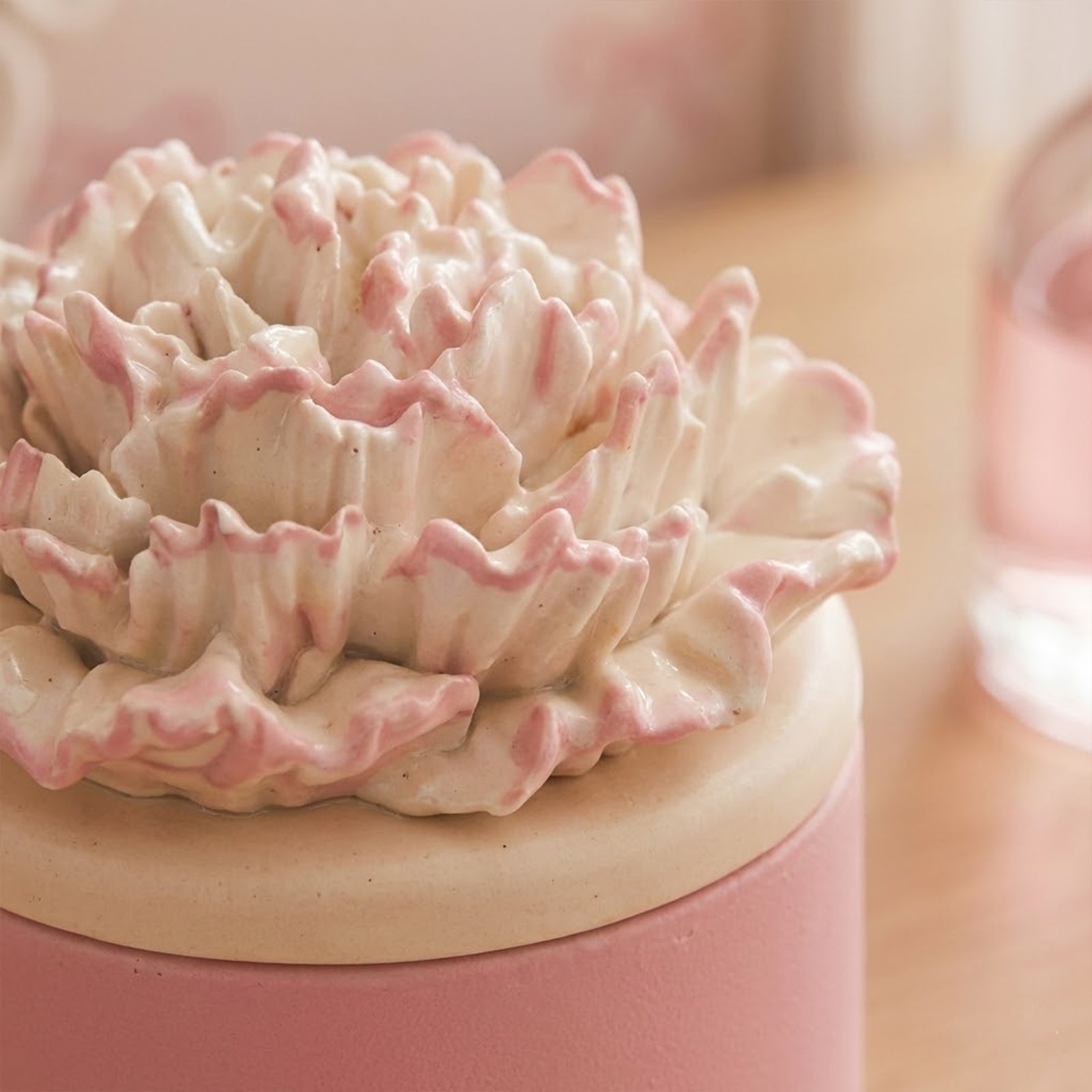 Close-up of a pink-edged carnation candle lid on a pink jar -Boowan Nicole