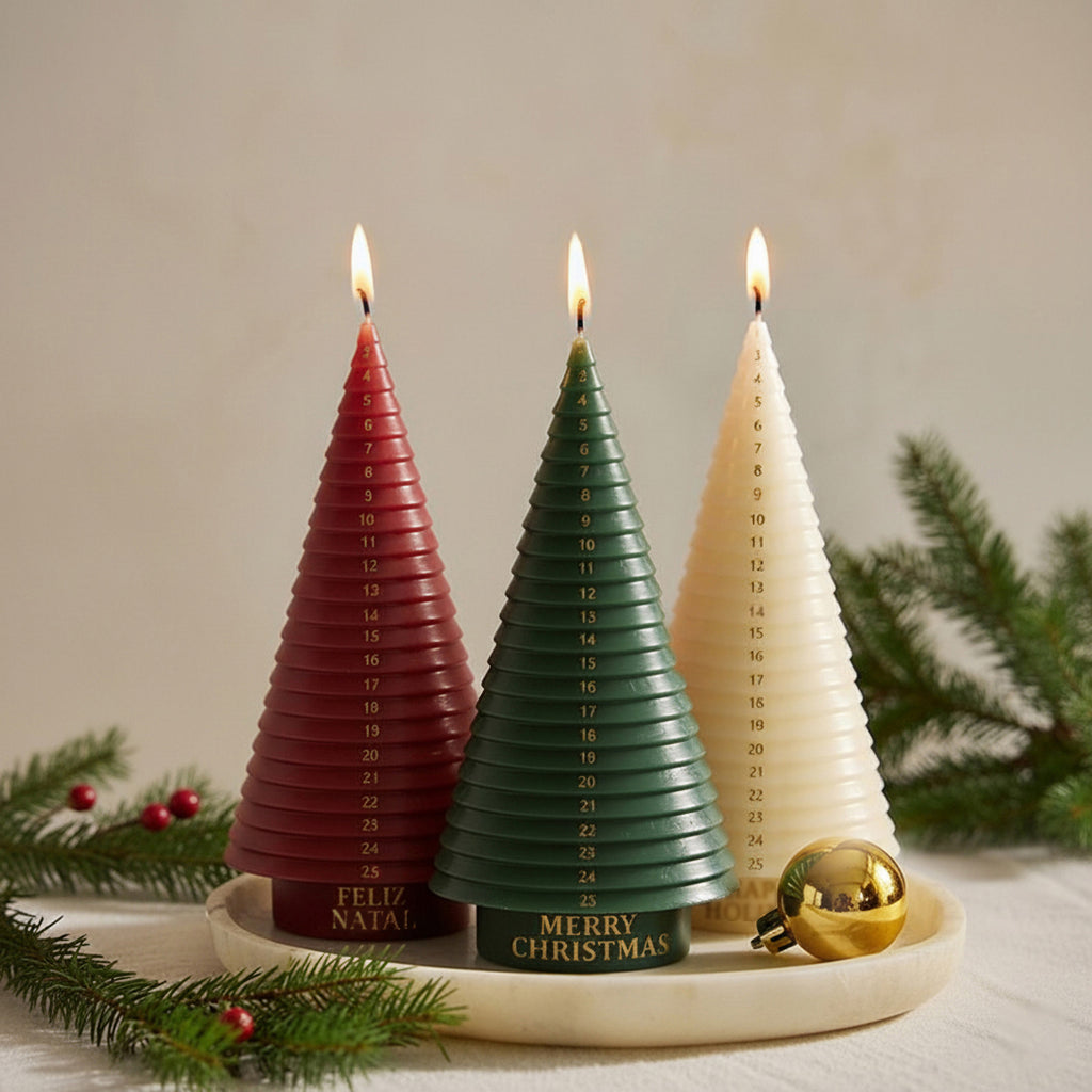 Three advent tree candles—red, green, ivory—burning on a tray with pine; numbered 1–25 - Boowan Nicole