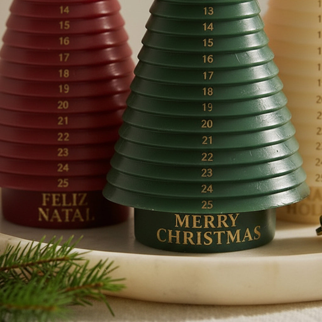 Close-up of green advent tree candle—“Merry Christmas” with gold numbers; red “Feliz Natal” behind - Boowan Nicole