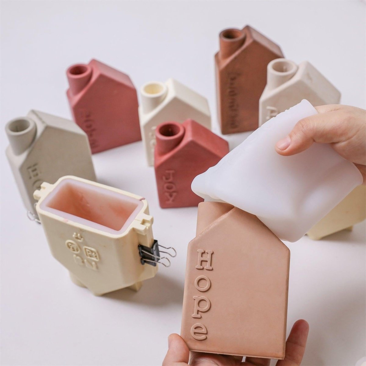 Unmolding house-shaped Advent candle holder with embossed “Hope” text from silicone mold - Boowan Nicole