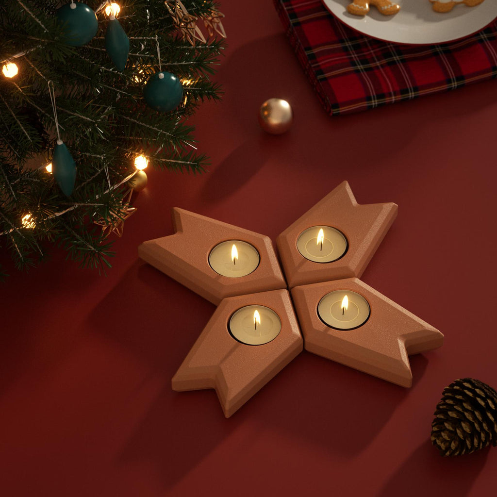 Star-shaped Advent candle holders with tea lights, displayed on a Christmas table with tree and festive décor - Boowan Nicole