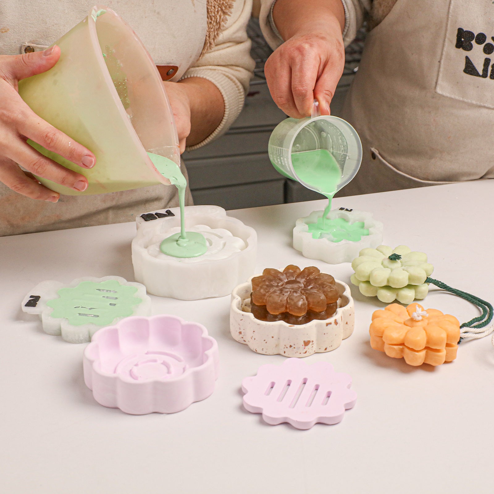 Crafting process: pouring light green casting material into flower soap and dish acrylic molds - Boowan Nicole
