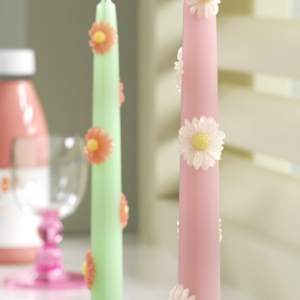 Delicate daisy-embellished pastel candles, handmade for a charming floral touch in modern home decor