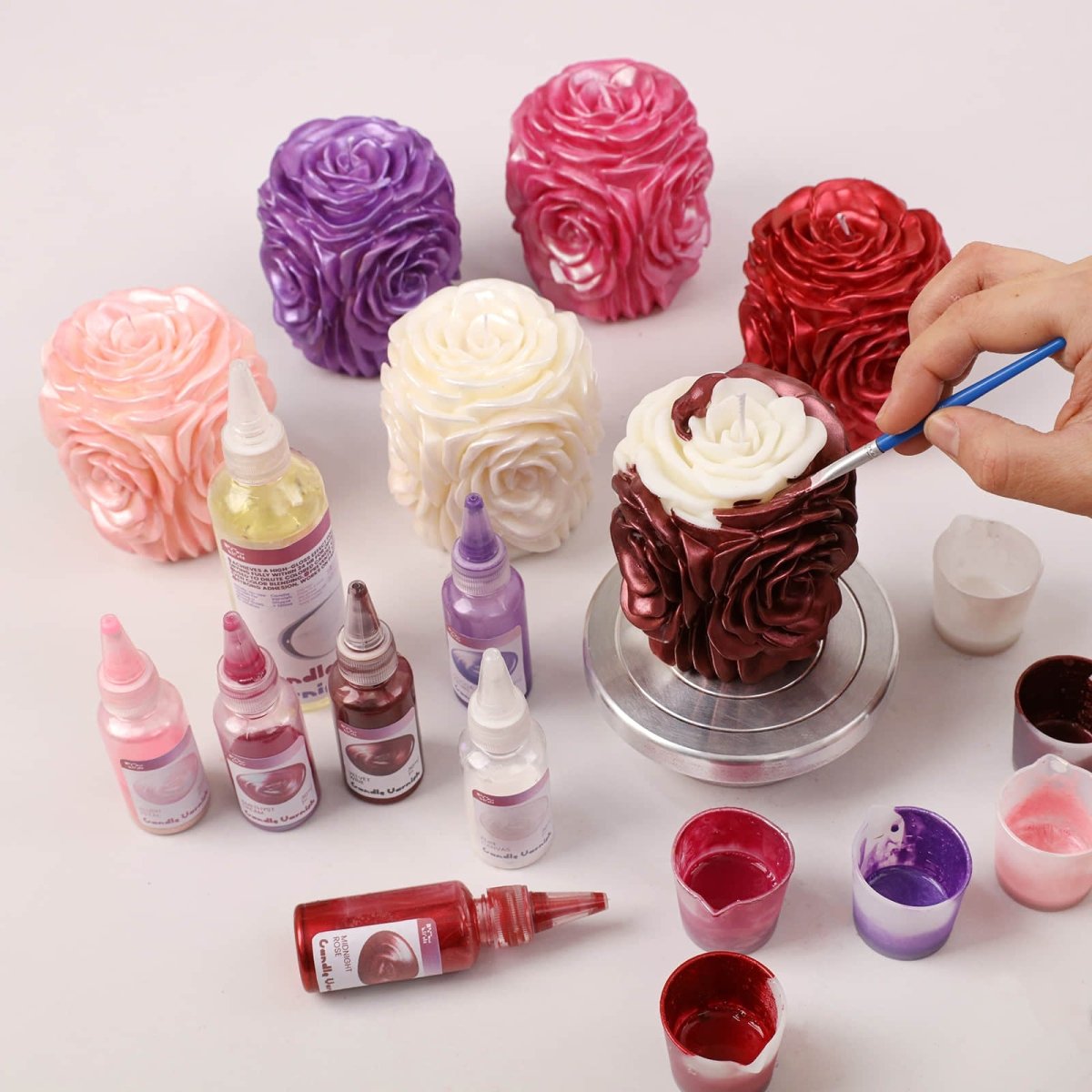 Hand painting details on rose pillar candle with liquid candle dye. - Boowan Nicole