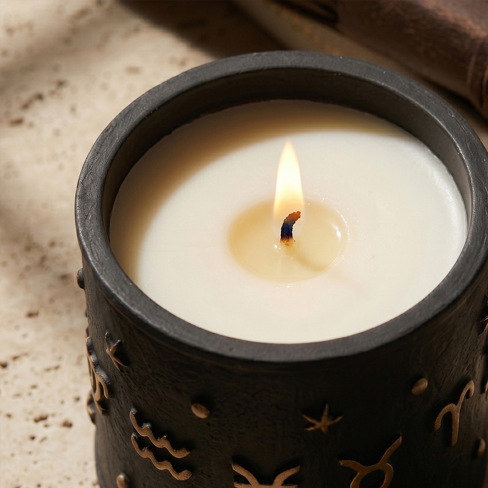 Close-Up of Burning Zodiac Candle - Soy Wax with Wooden Wick in Black Embossed Jar - Boowan Nicole