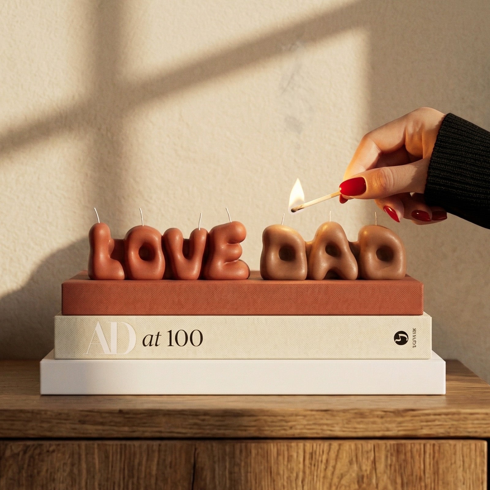 Lighting LOVE & DAD Bubble Letter Scented Candles on Stacked Books - Boowan Nicole
