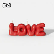 Red bubble-shaped "LOVE" letter candle with BN logo, displayed against a white background. -Boowan Nicole