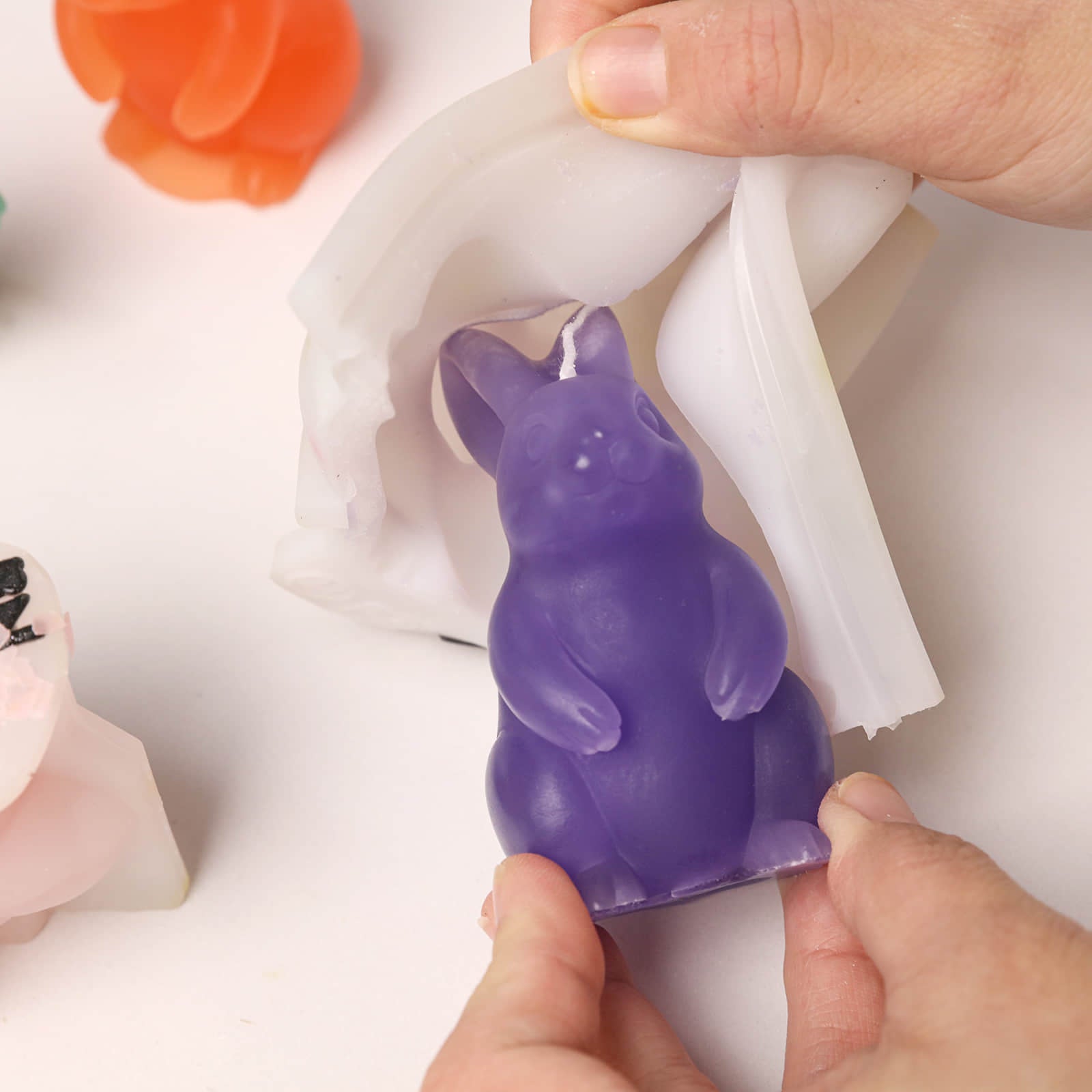 De-molding a purple standing Bunny Buddy candle from a white silicone mold - Boowan Nicole