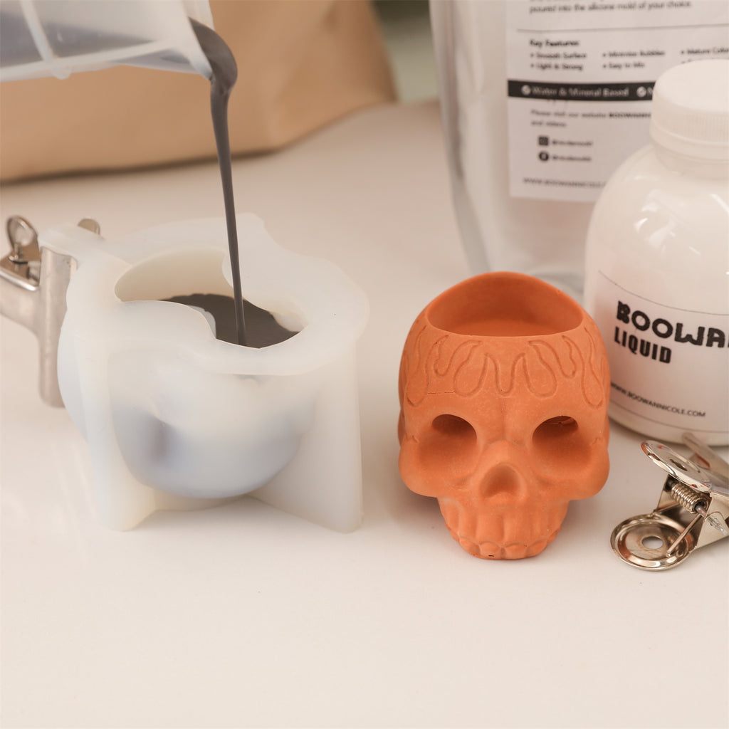 Pouring Boowannite into a skull-shaped silicone mold