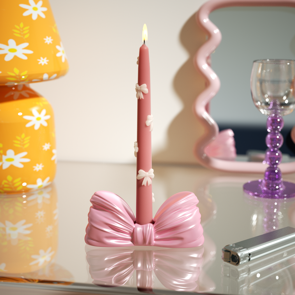 Elegant pink bow-shaped candle holder with a daisy-embellished taper candle, perfect for adding charm to any occasion-Boowan Nicole