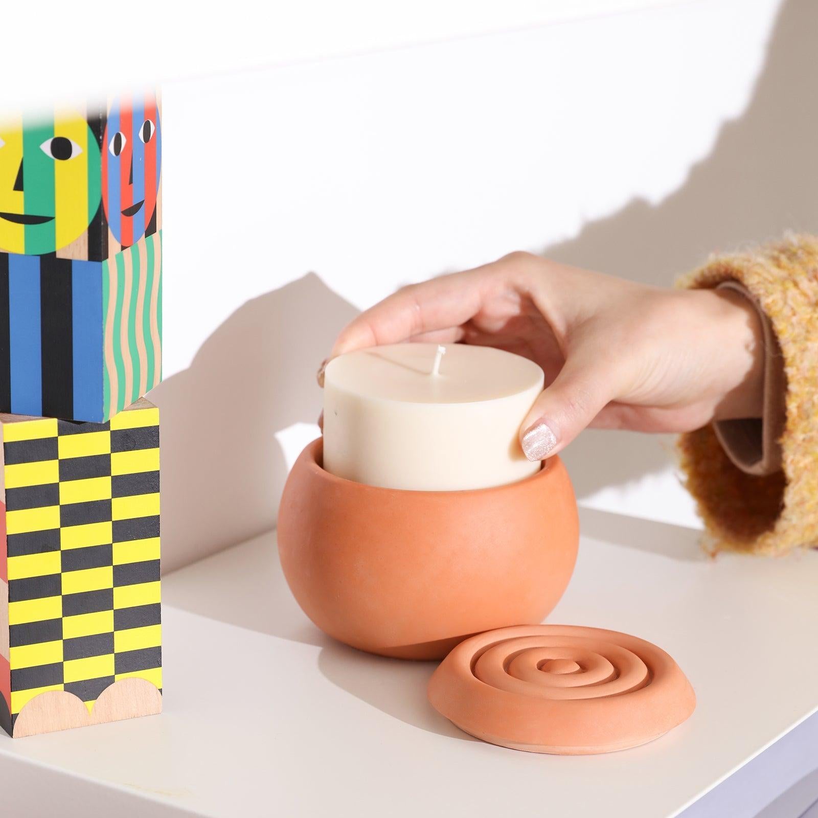 Place the candle refills in the ball candle jar on the table.