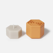 Hexagonal candle jars and candle refills made using silicone molds.