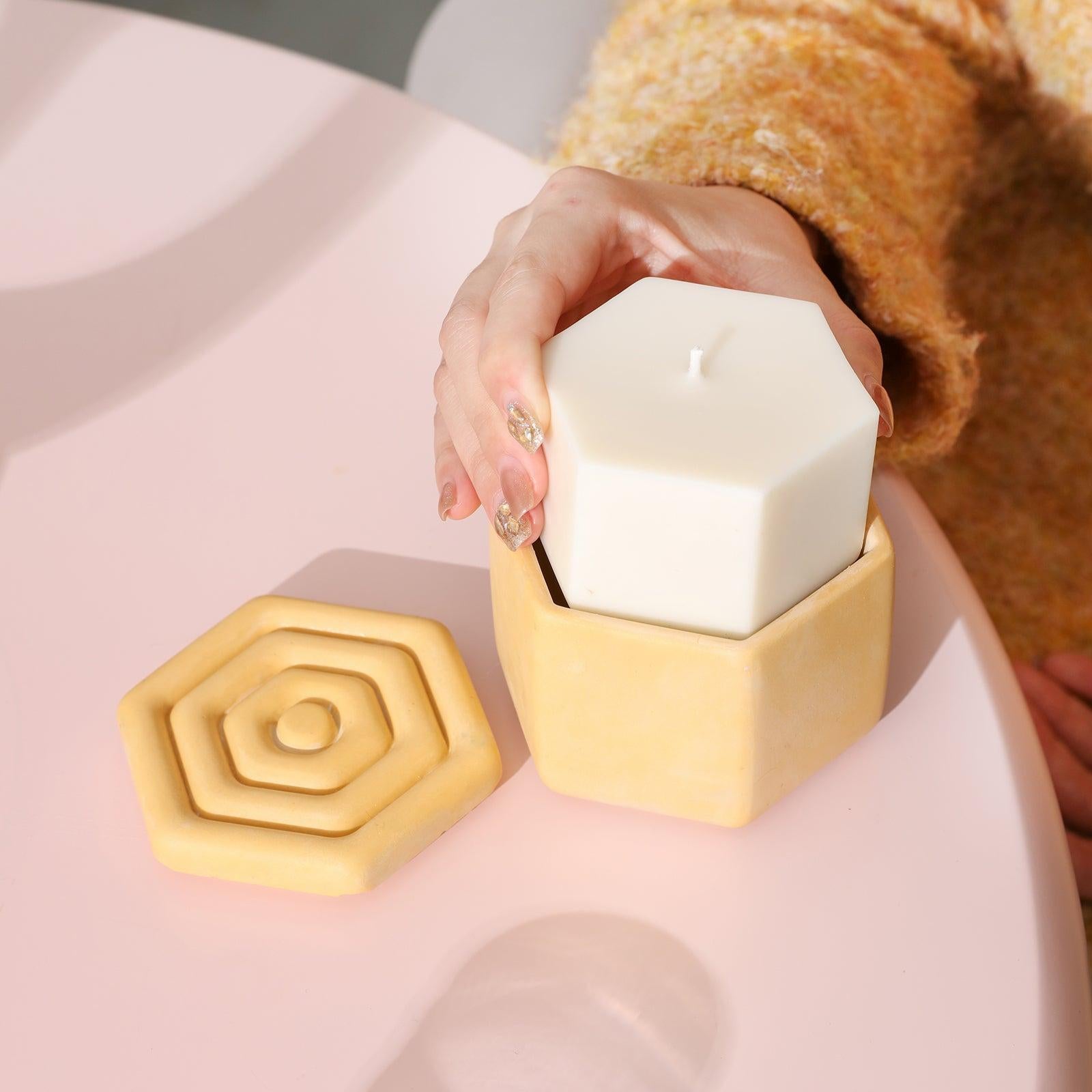 The completed candle refills are placed in hexagonal candle jars, reflecting the brand's environmental and sustainable concepts.