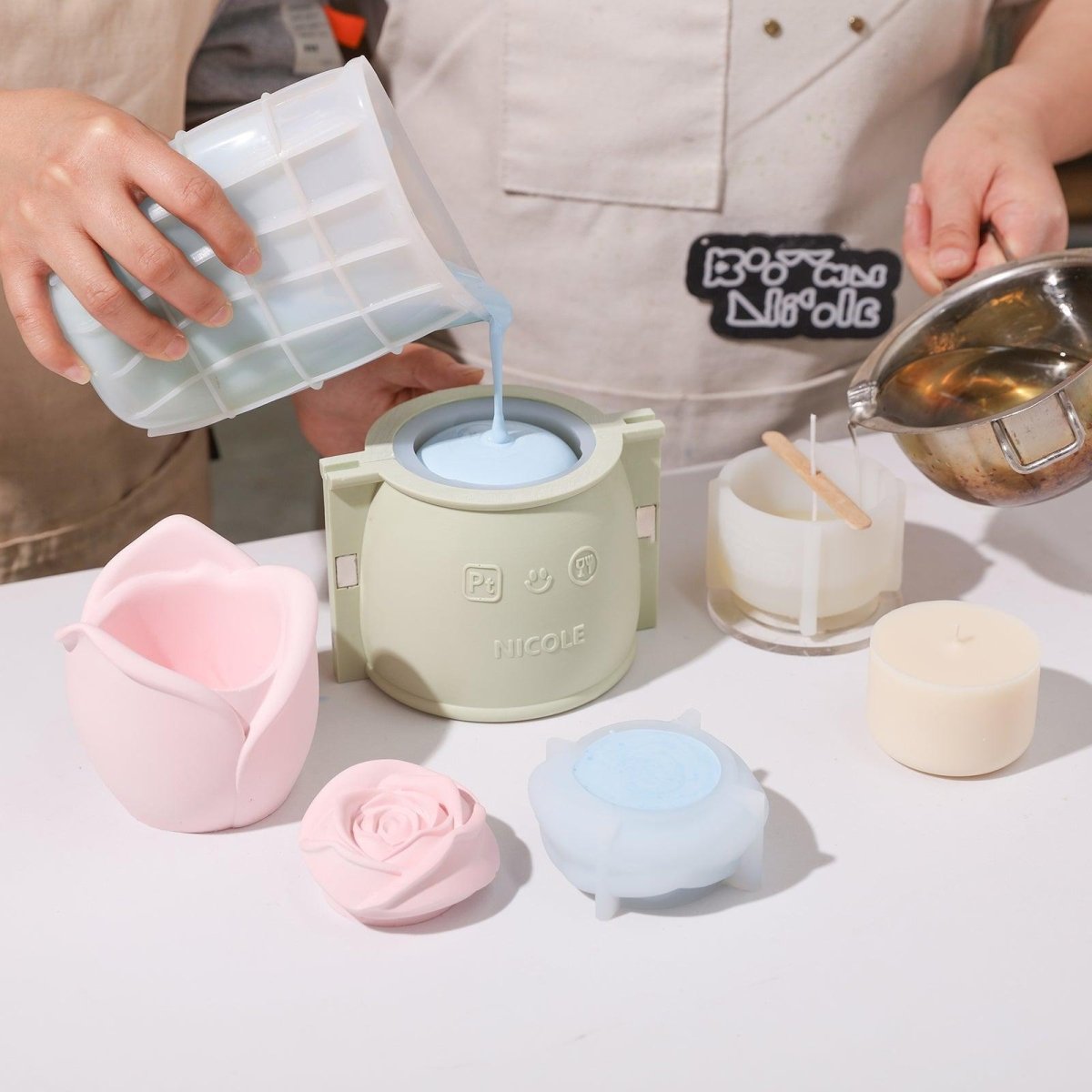 Pour blue boowannite material into silicone mold to make Rose Reverie Candle Jar-Boowan Nicole