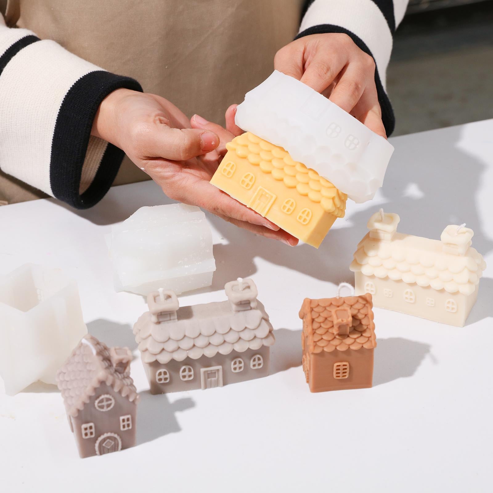 The completed house candle comes out of the silicone mold, and the completed house candle is placed next to it.
