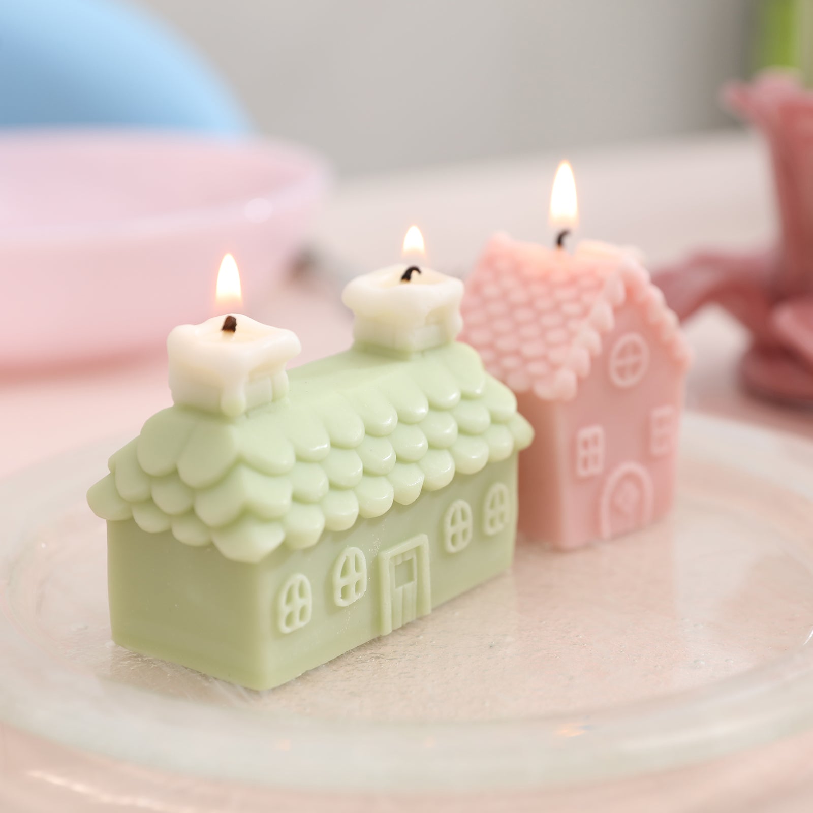 Single and double chimney house candles being lit close together.