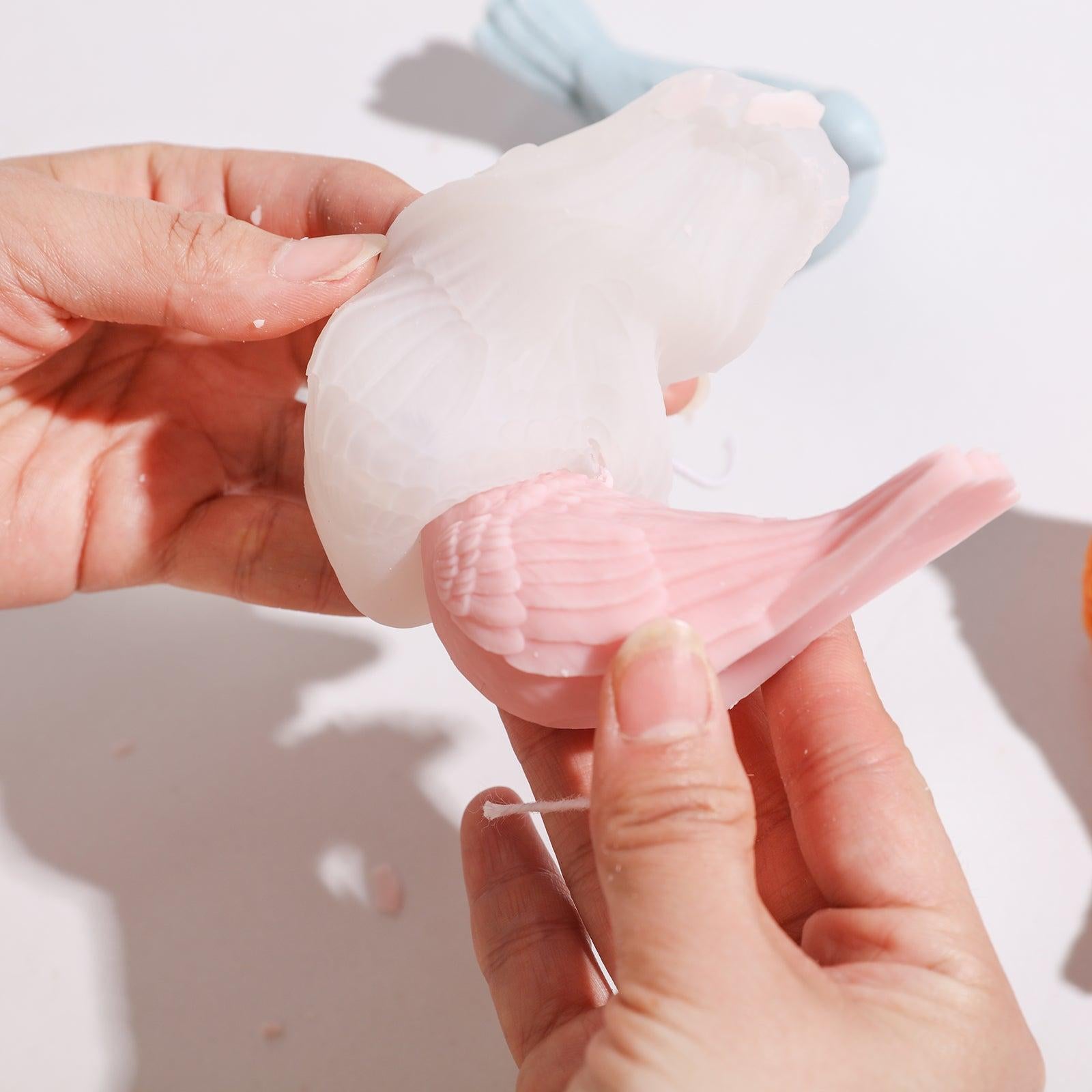 The finished peace dove-shaped tea light candle comes out of the silicone mold and is easy to operate. Designed by Boowan Nicole.