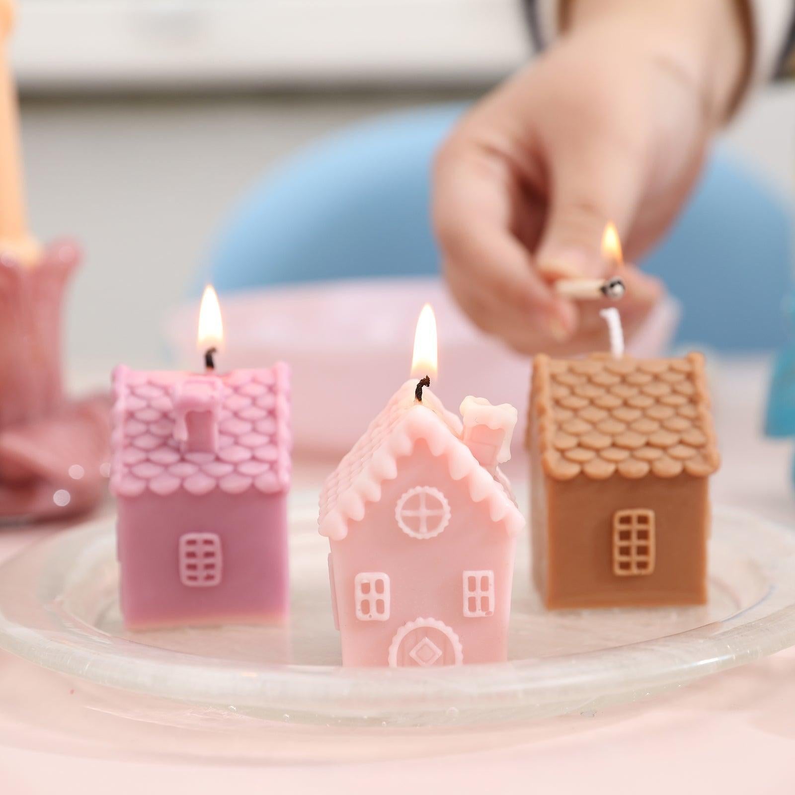 Light three single chimney house candles in glass trays.